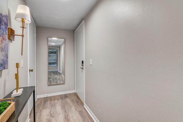 hallway with light hardwood / wood-style flooring