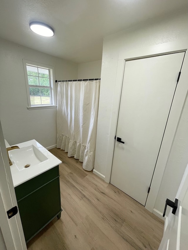 1515 County Road 826, Buna, TX 77612 - full bathroom with wood finished floors, vanity, and curtained shower