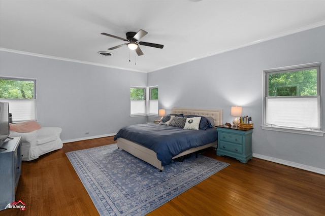 bedroom with dark wood-type flooring, visible vents, baseboards, and ornamental molding