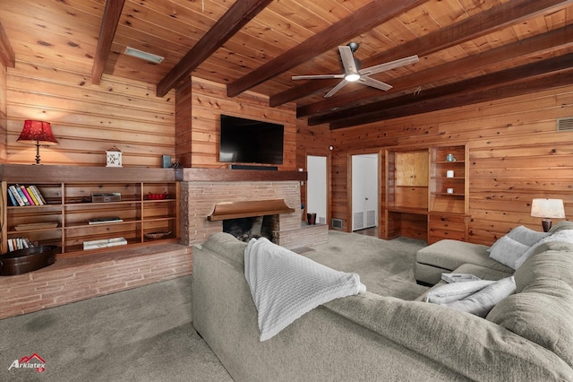carpeted living room featuring wood walls, wooden ceiling, beam ceiling, a fireplace, and ceiling fan