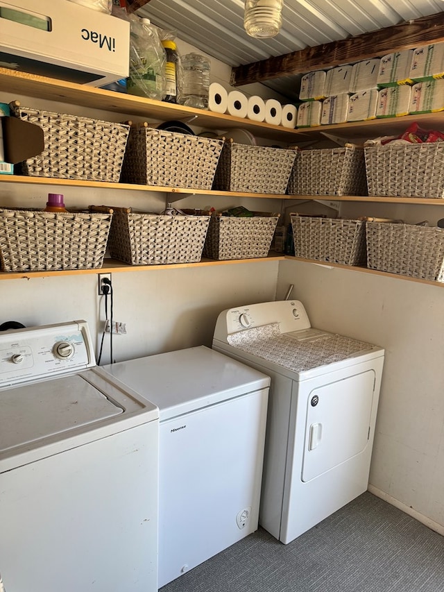 laundry room with laundry area, carpet flooring, and washing machine and dryer