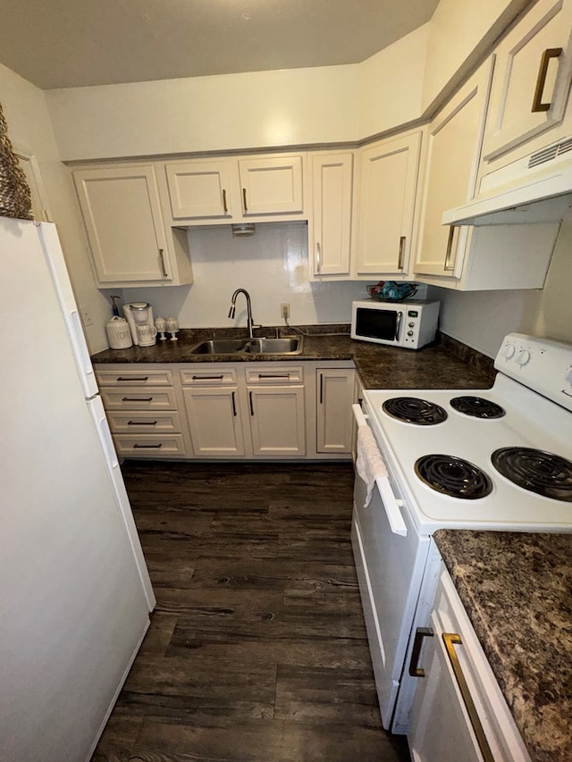 kitchen featuring dark wood-type flooring, white appliances, white cabinets, and a sink