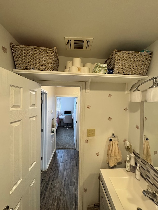 bathroom featuring visible vents, vanity, and wood finished floors