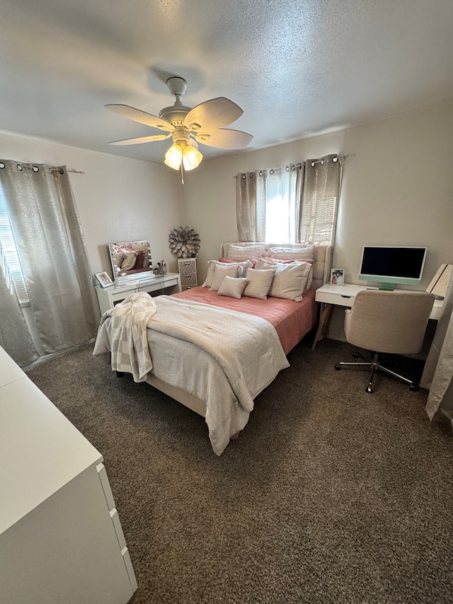 bedroom with carpet floors, ceiling fan, and a textured ceiling