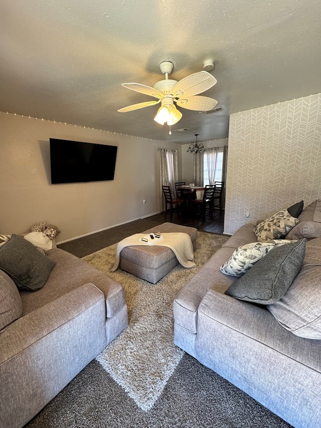 living room featuring a textured ceiling, ceiling fan, and carpet