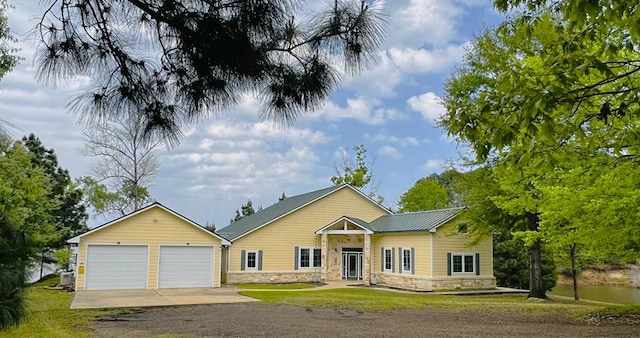 320 Nine Mile Rd, Milam, TX 75959 - view of front of home with driveway, a front yard, and stone siding