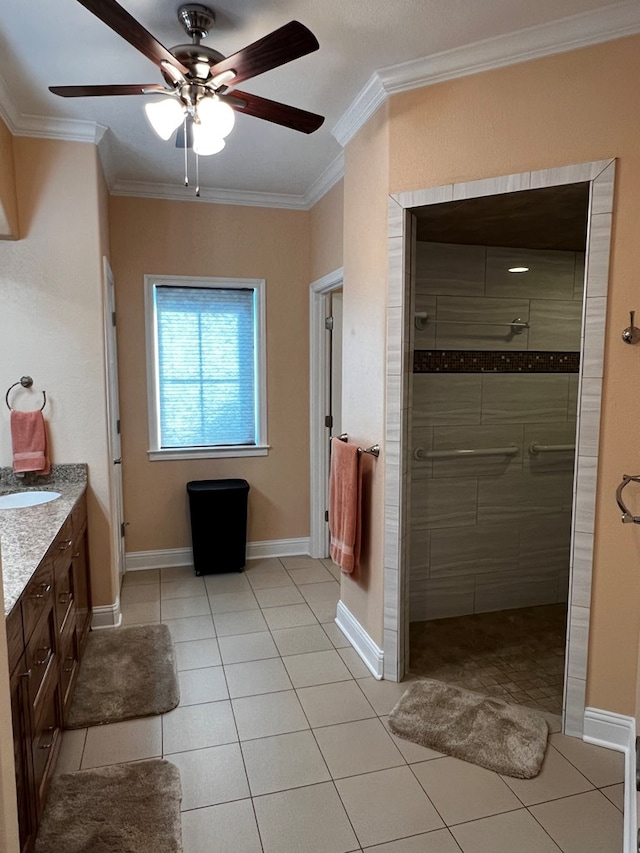 bathroom featuring ornamental molding, vanity, tile patterned flooring, and a tile shower