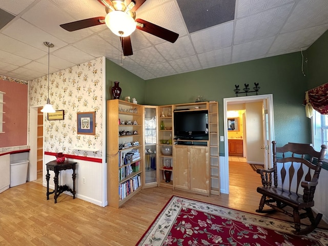 living room featuring wood-type flooring and ceiling fan