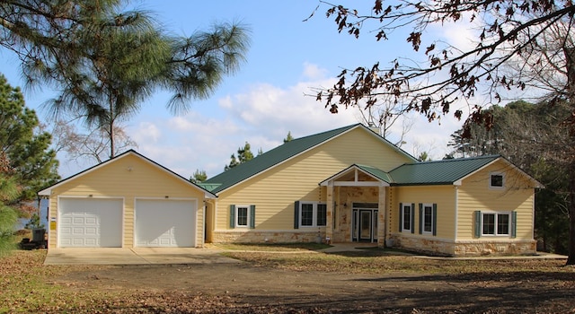 view of front facade with a garage and central AC