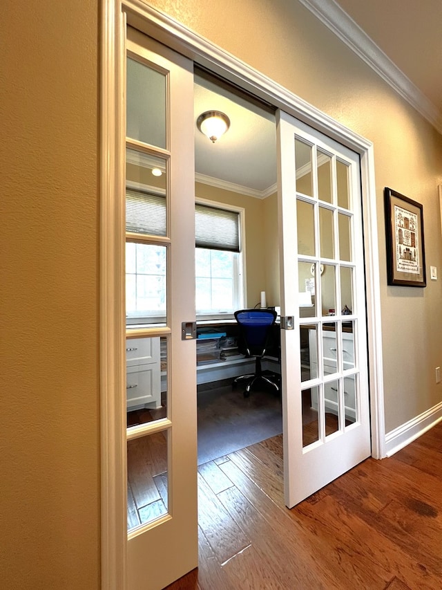 doorway to outside with ornamental molding, wood-type flooring, and french doors