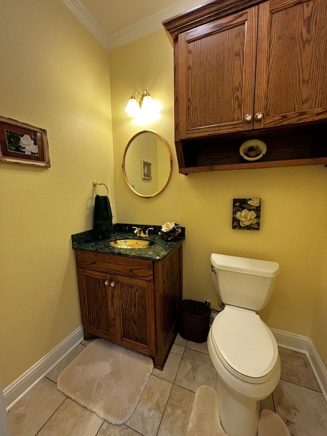 bathroom with vanity, crown molding, and toilet