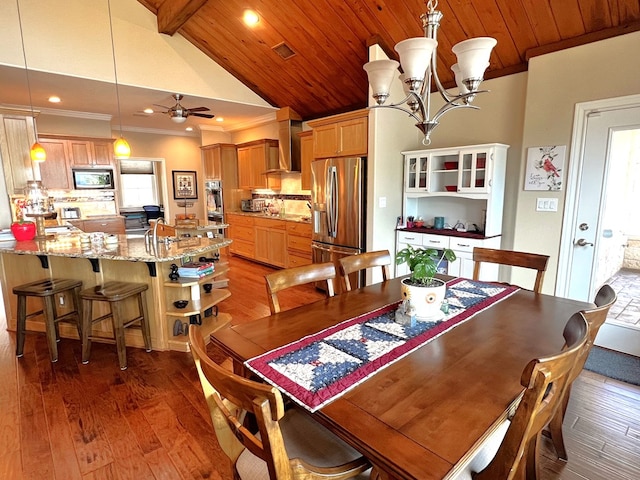 dining area with ceiling fan with notable chandelier, vaulted ceiling with beams, ornamental molding, dark wood-type flooring, and wooden ceiling