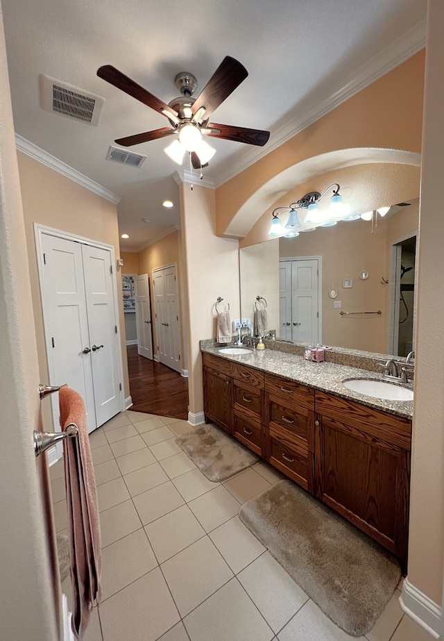 bathroom with tile patterned flooring, ornamental molding, vanity, and ceiling fan