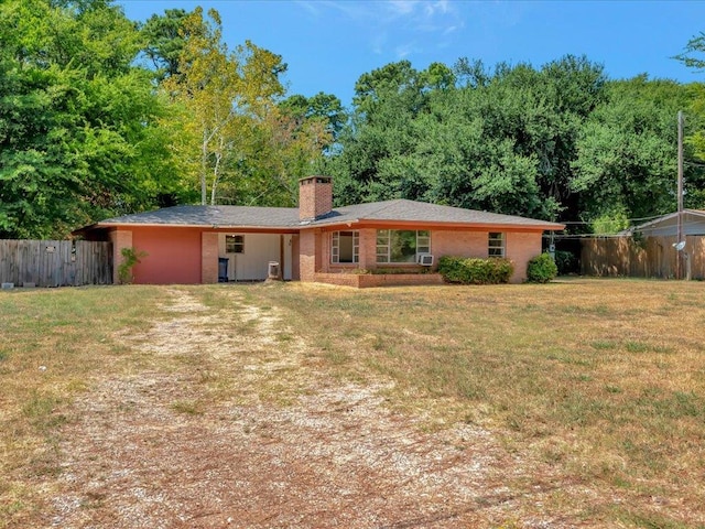 rear view of property with a lawn