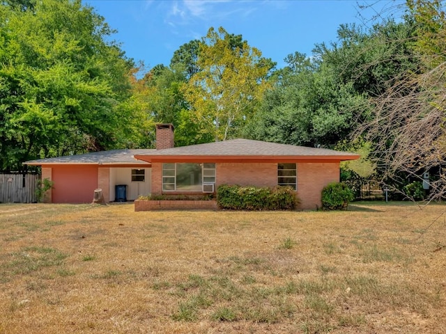 back of house featuring a lawn