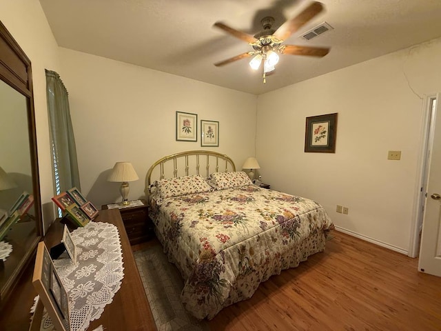 bedroom with hardwood / wood-style floors and ceiling fan