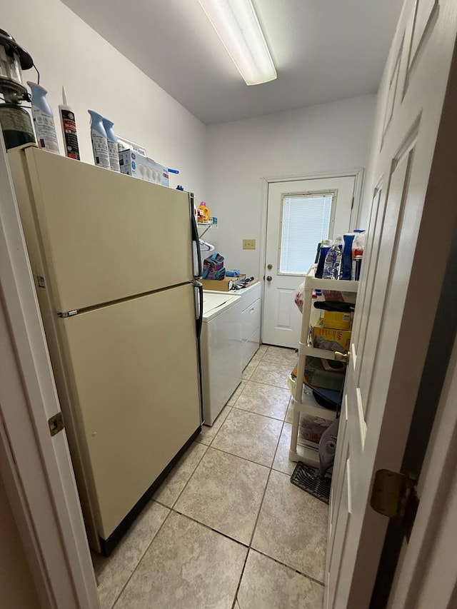 washroom featuring independent washer and dryer and light tile patterned floors