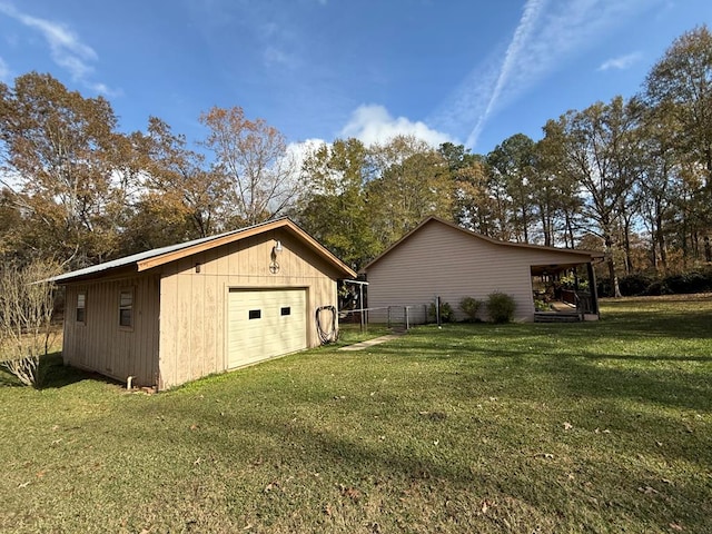 exterior space featuring a yard, a garage, and a carport