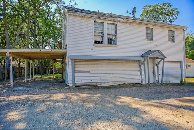 view of front of home with a carport and a garage