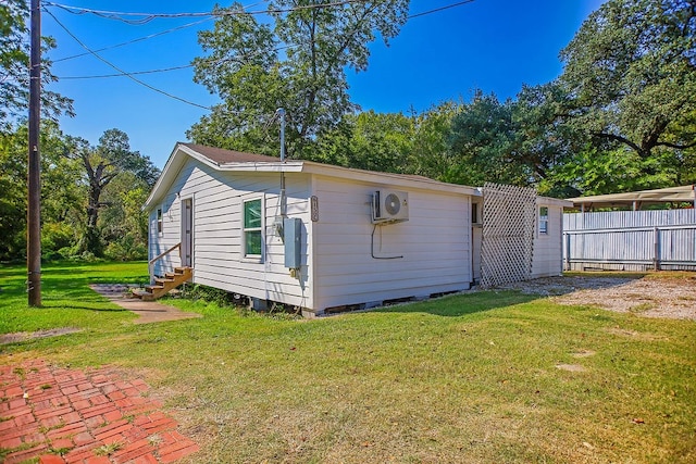 back of house featuring a yard and ac unit