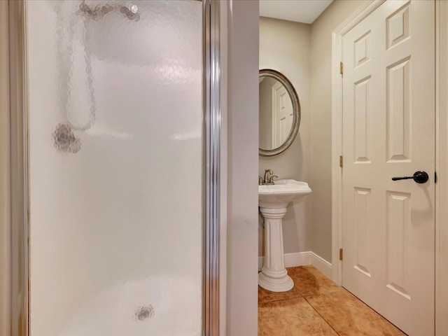 bathroom with tile patterned floors, an enclosed shower, and sink