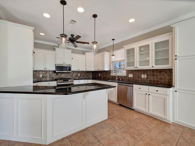 kitchen featuring stainless steel appliances, ceiling fan, sink, white cabinetry, and hanging light fixtures