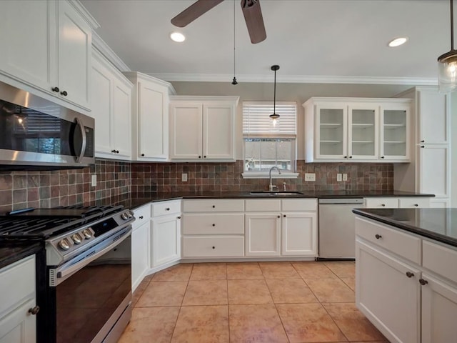 kitchen featuring pendant lighting, sink, light tile patterned floors, and stainless steel appliances