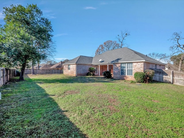 rear view of house with a yard