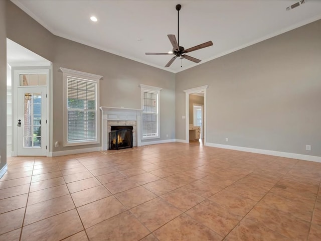 unfurnished living room with light tile patterned floors, ceiling fan, and crown molding