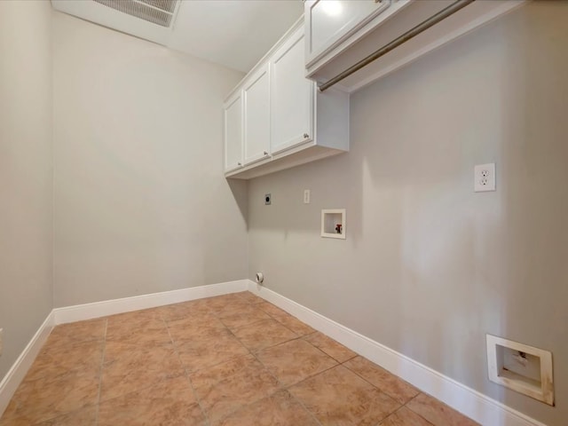 washroom with hookup for an electric dryer, cabinets, and washer hookup