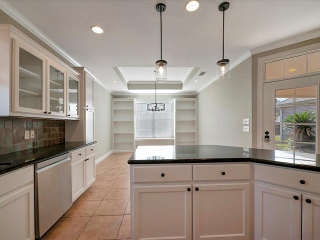 kitchen featuring hanging light fixtures, light tile patterned floors, a raised ceiling, stainless steel dishwasher, and white cabinets