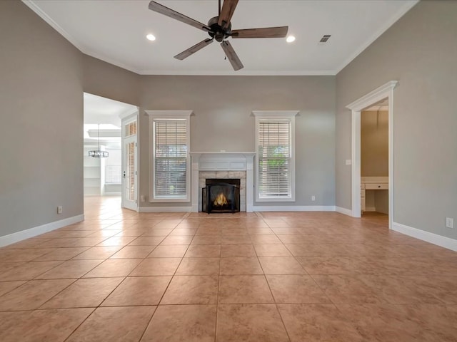 unfurnished living room with a fireplace, light tile patterned floors, ceiling fan, and ornamental molding