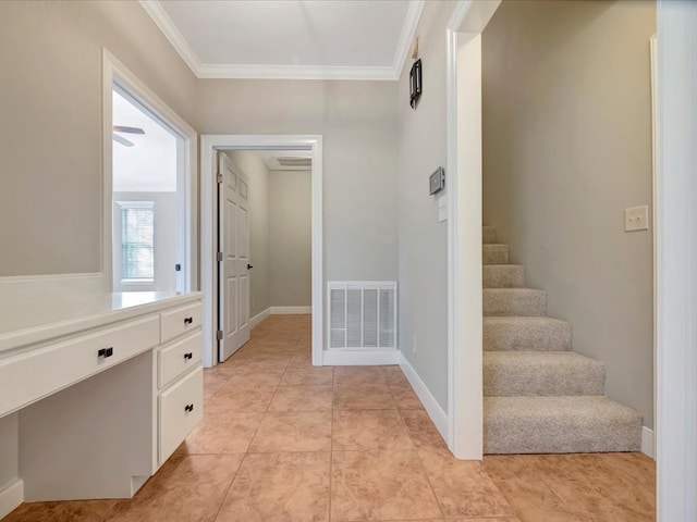 hall with crown molding and light tile patterned floors