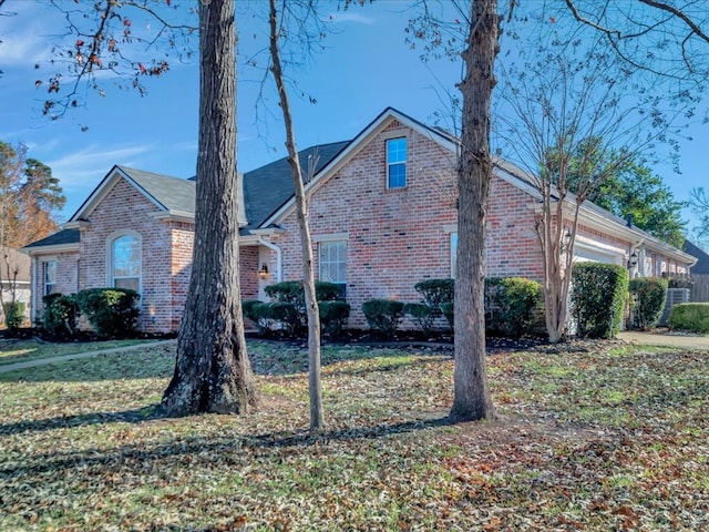 view of side of home featuring a yard and a garage