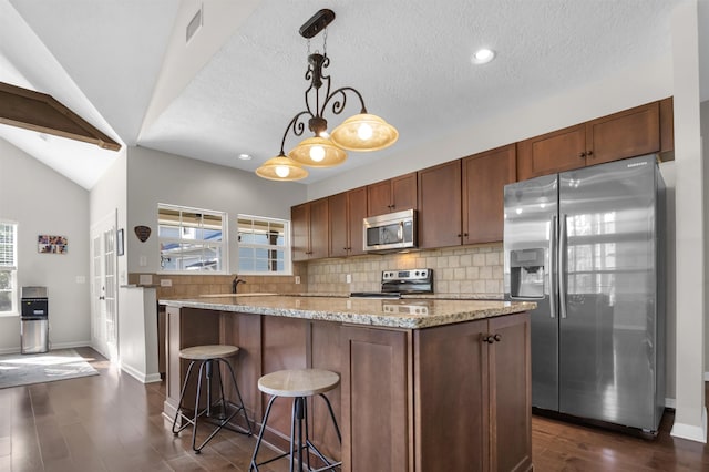 346 Northview Dr, Brookeland, TX 75931 - kitchen with stainless steel appliances, dark wood-style flooring, backsplash, plenty of natural light, and a textured ceiling