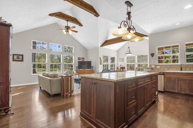 kitchen with a textured ceiling, decorative light fixtures, dark hardwood / wood-style flooring, and light stone counters