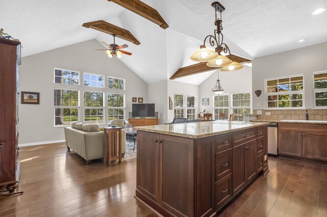 346 Northview Dr, Brookeland, TX 75931 - kitchen featuring a ceiling fan, open floor plan, dark wood-type flooring, high vaulted ceiling, and light stone counters