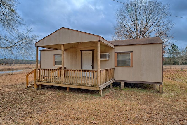 view of front of home featuring roof with shingles and a deck with water view