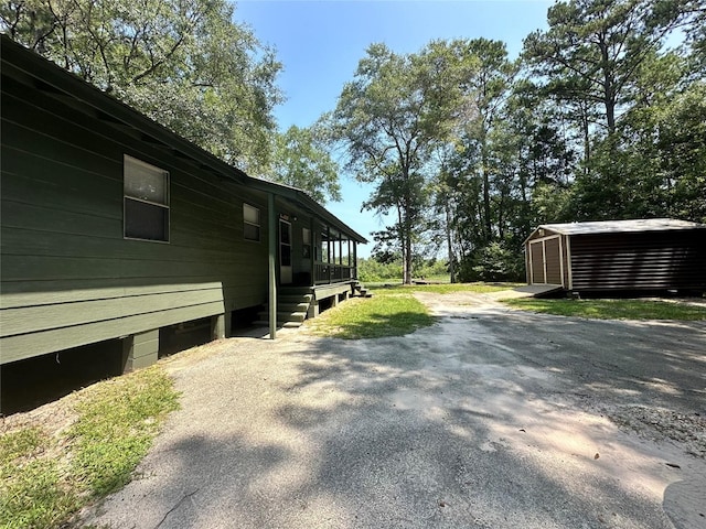 view of side of property featuring a storage unit