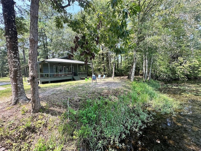 view of yard featuring a deck with water view