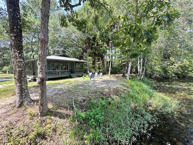 view of yard featuring covered porch