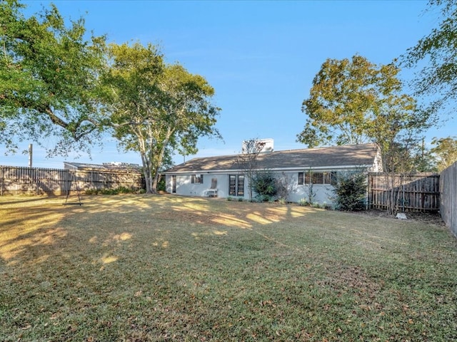 rear view of house with a lawn