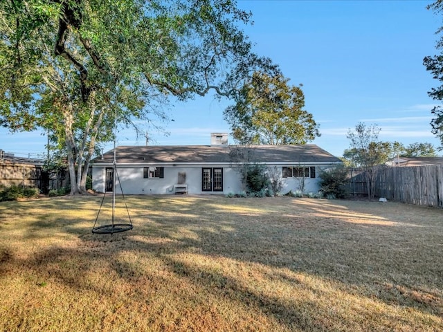 back of house with a yard