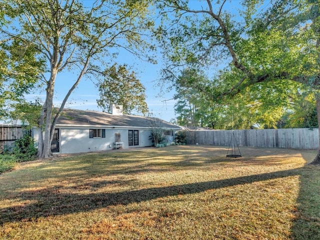 back of house featuring a lawn