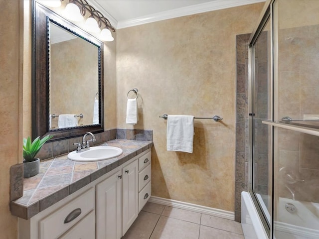 bathroom with tile patterned flooring, vanity, enclosed tub / shower combo, and ornamental molding