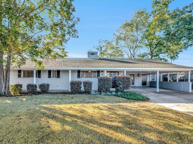 ranch-style house featuring a front yard and a carport