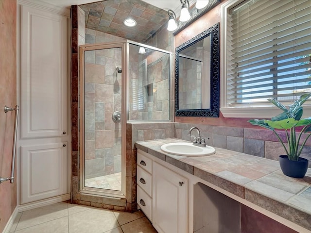 bathroom featuring vanity, tasteful backsplash, tile patterned floors, and a shower with shower door