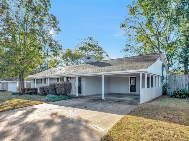 ranch-style home with a front yard and a carport