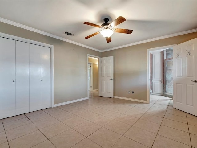 unfurnished bedroom featuring light tile patterned floors, a closet, ceiling fan, and ornamental molding