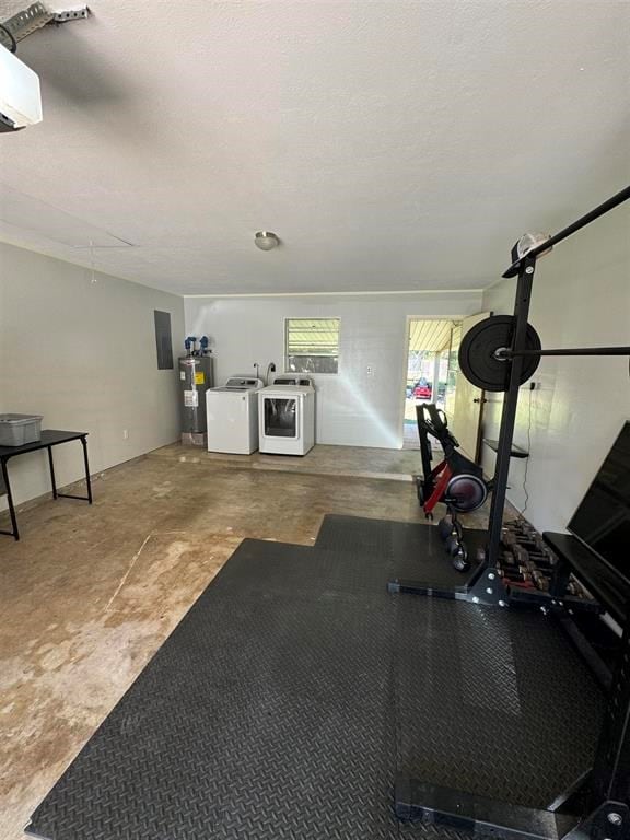 exercise room featuring a textured ceiling, washing machine and dryer, and water heater